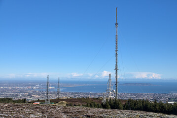 Obraz premium Beautiful view of Three Rock TV transmitter antenna viewed from Fairy Castle (Two Rock Mountain), Dublin Mountains, Ireland. Single cellular tower in fir fores. Vertical view. Dublin Bay in background