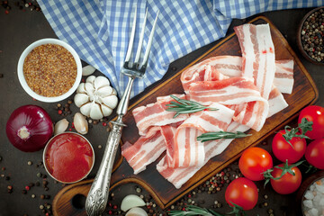 Raw meat with spices in a composition with kitchen accessories.