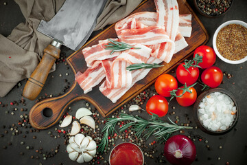 Raw meat with spices in a composition with kitchen accessories.