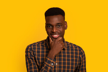 Handsome African American Guy Touching Chin And Looking At Camera With Interest