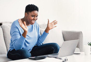 Black woman having video call using laptop and gesturing
