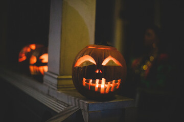 Close-up of illuminated jack o lanterns on retaining wall