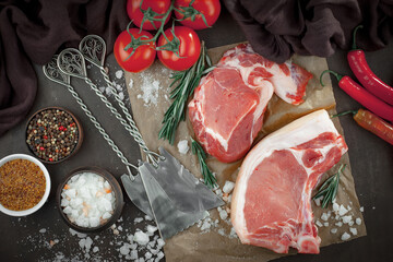 Raw meat with spices in a composition with kitchen accessories.