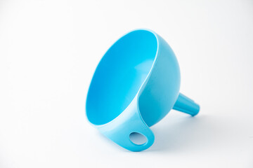 Close-up of blue funnel on white background in horizontal, with copy space