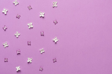Lilac flowers border on purple background with copy space. Flat lay. Top view. Holiday or wedding background