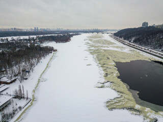 The freezing Dnieper river in Kiev. Snowy textures on the freezing river. Aerial drone view. Winter snowy morning.