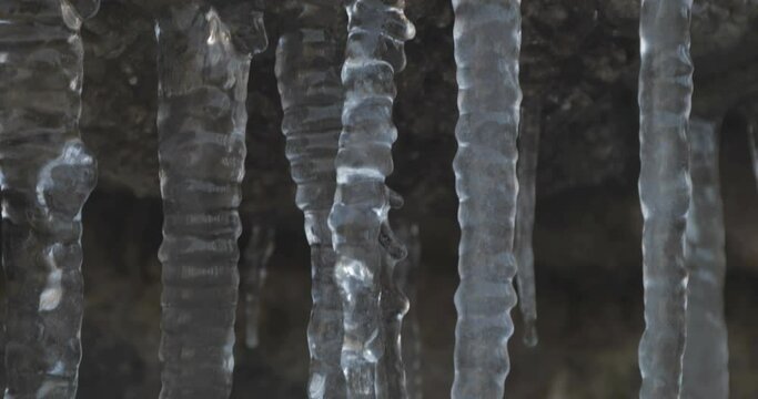 Icicles hanging off of a rock, winter landscape at lessinia park
