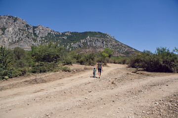 Obraz premium boy child travels with his father through the mountains in the summer in the Crimea