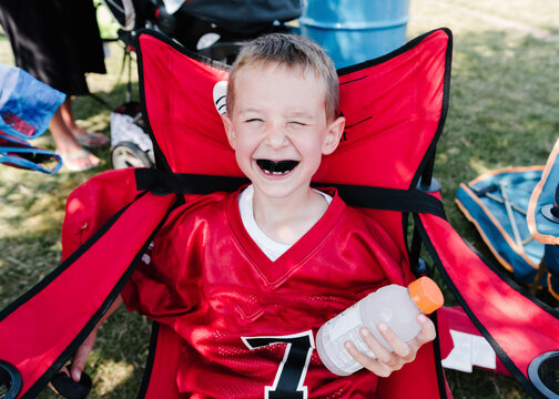 High angle view of boy with mouthguard sitting on chair