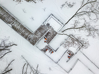 Cleaning the snowy stairs. Aerial drone view. Winter snowy day.