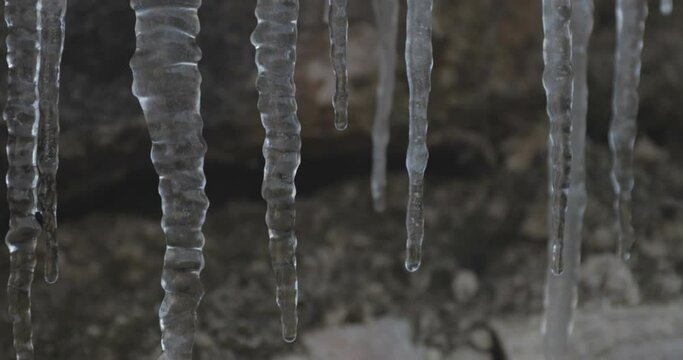 Icicles hanging off of a rock, winter landscape at lessinia park