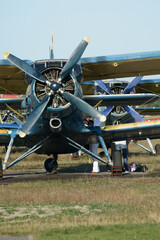 restored old yellow biplane with one engine per propeller