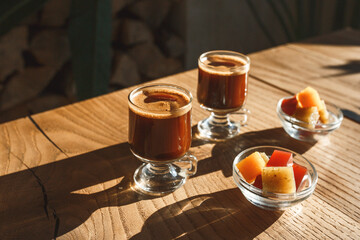 Coffee and sweets on a wooden table in a rustic style.