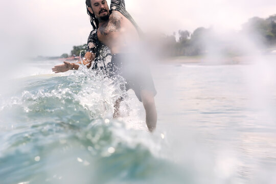 Man balancing while surfing in sea