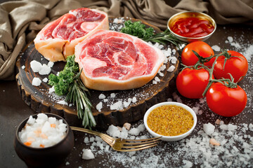 Raw meat with spices in a composition with kitchen accessories.
