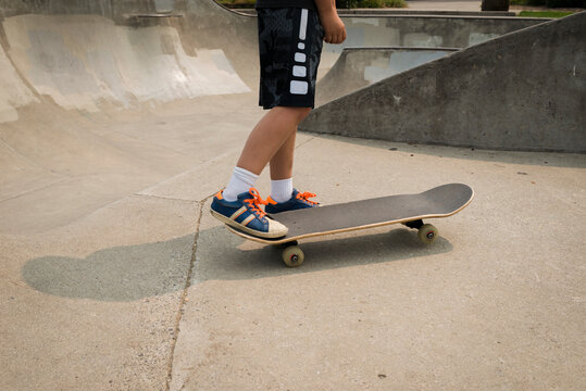Low section of boy skateboarding on sports ramp at park