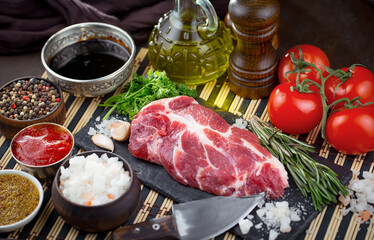 Raw meat with spices in a composition with kitchen accessories.