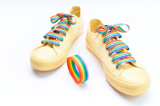 Pair of yellow shoes with rainbow laces. lgtb concept
