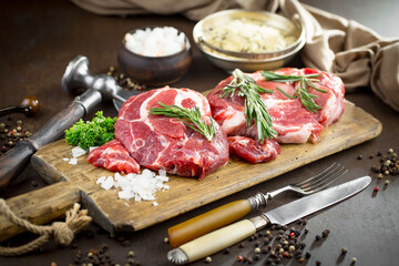 Raw meat with spices in a composition with kitchen accessories.
