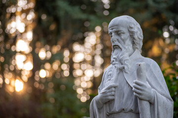 Christian Marble sculpture at sunset with bokeh