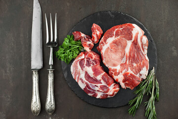 Raw meat with spices in a composition with kitchen accessories.