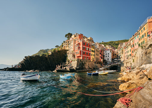 Boats at sunny bay by coastal European town