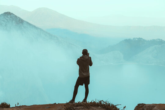 Young man looking at Ijen lake