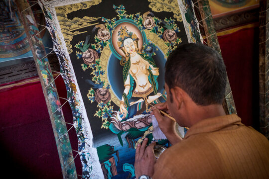 A Nepalese artists finishes a painting in a workshop near Bhaktapur