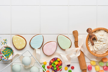 Easter baking background. Concept of cooking traditional festive food Easter gingerbread and bread on white background. Spring cooking time. Space for a text.