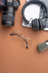 studio microphone, headphones and laptop, camera and glasses. Top view, blogger or streamer with space