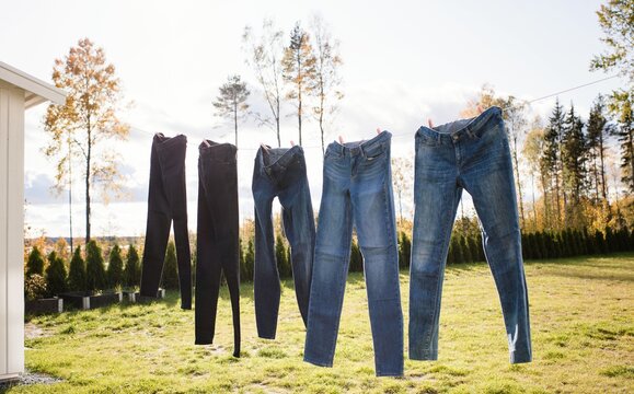 jeans hanging on an outdoor washing line drying in the sun