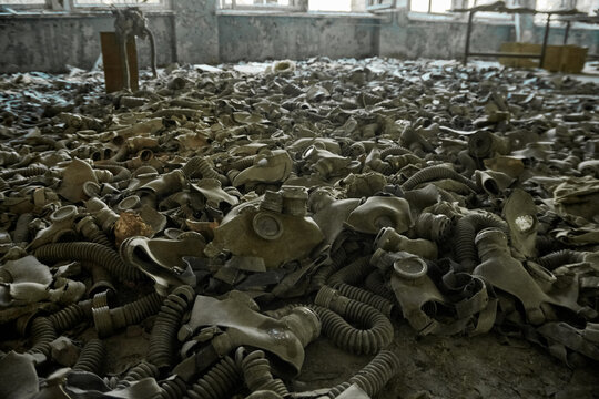 Gas masks on the floor with an old television in an abandoned middle school in Pripyat