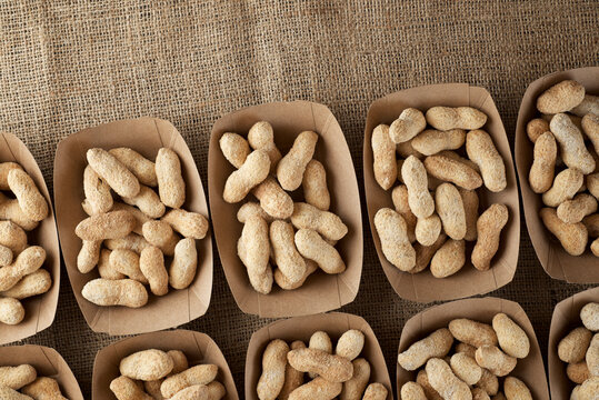Peanuts with shell in disposable cardboard boxes.