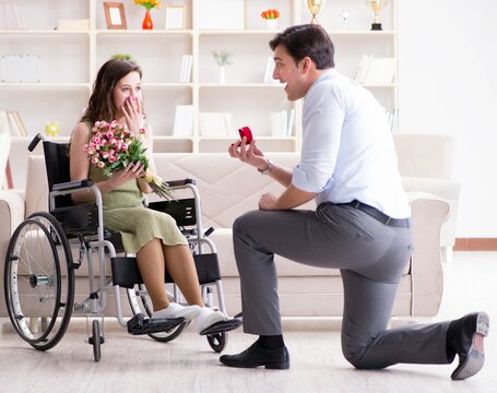 Man making marriage proposal to disabled woman on wheelchair