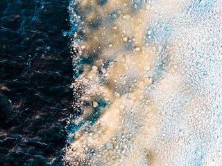 Fototapeta premium Amazing background texture - sea waves under ice in winter