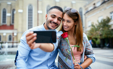 Happy couple making a selfie with mobile phone. Dating, love, relationships, lifestyle concept