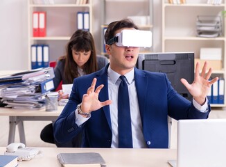 Employee with virtual reality glasses in office