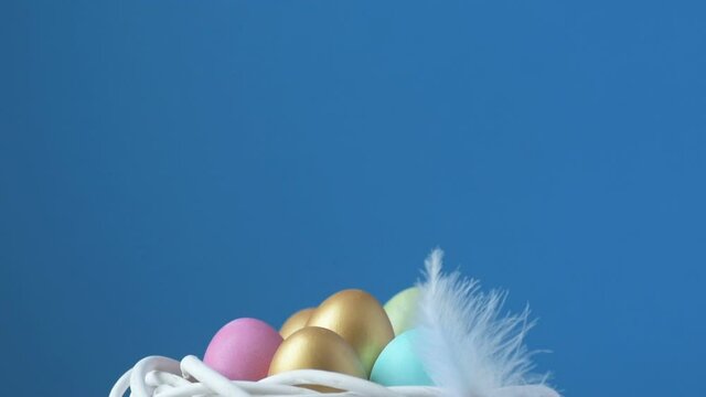 Feather falling on colorful easter eggs