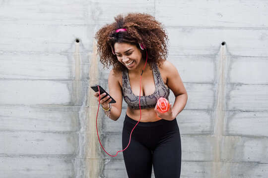 Happy Curvy African American Woman Working Out and Listening Music