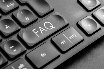 graue "FAQ" Taste auf einer dunklen Tastatur