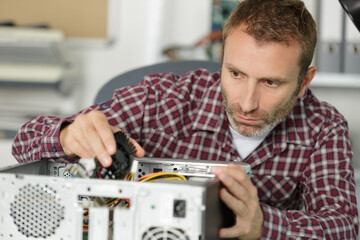 computer repairman specialist repairing computer desktop