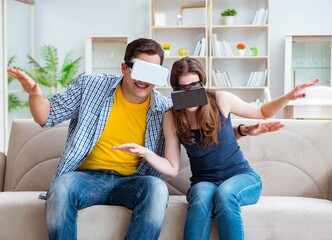 Young family playing games with virtual reality glasses