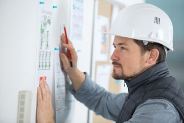 worker reviewing instructions on board