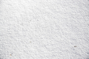 Texture of white fresh snow sparkling in the sun