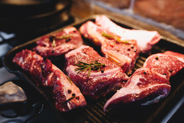 Preparing steak on the grill pan with seasonings