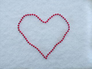 heart shaped beads on snow in winter valentine