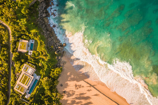 Aerial view of a luxury resort facing the Ocean with waves crashing on the beach on a paradise island, Mar&iacute;a Trinidad S&aacute;nchez, Dominican Republic.