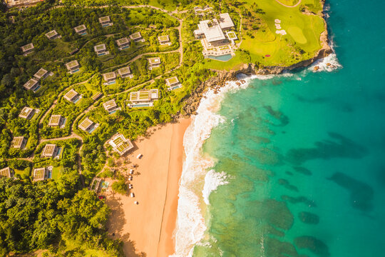 Aerial view of a luxury resort facing the Ocean with waves crashing on the beach on a paradise island, Mar&iacute;a Trinidad S&aacute;nchez, Dominican Republic.