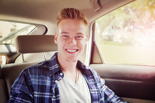 Smiling Teenager Riding In The Backseat Of A Car