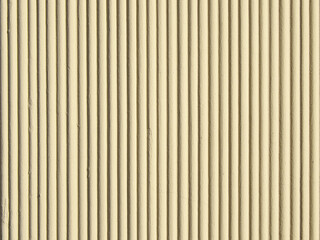 Light beige wavy plaster background.